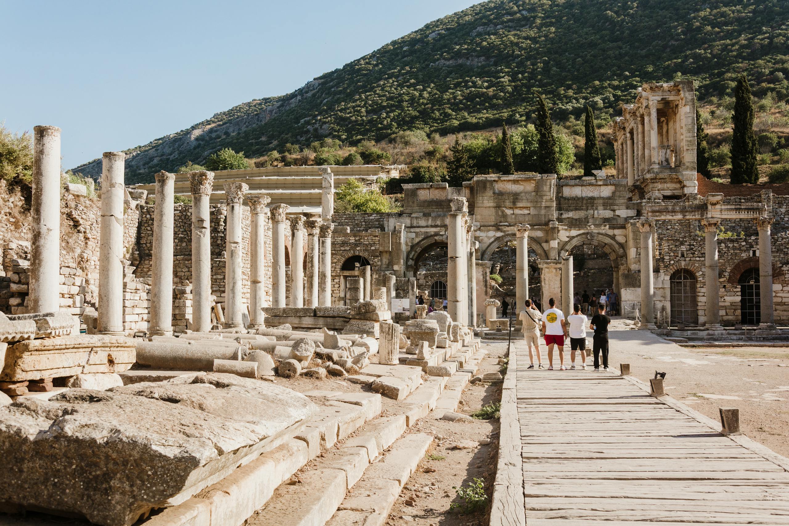 Visitors walking among the ruins at Ephesus
